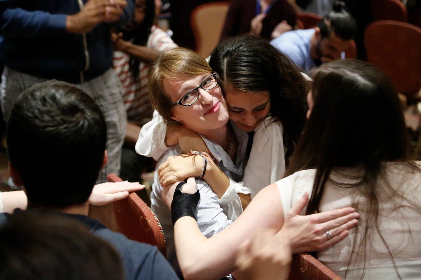 Two delegates embracing at the close of a conference