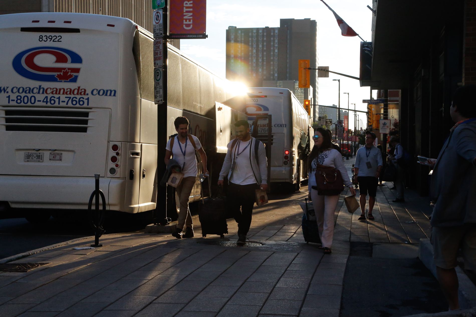 Delegates boarding coaches at golden hour